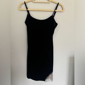 Mini black dress with rhinestone dangles.